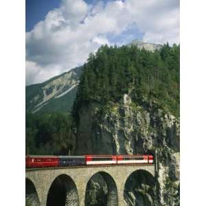  Train Passes into a Tunnel in the Mountains of Switzerland 