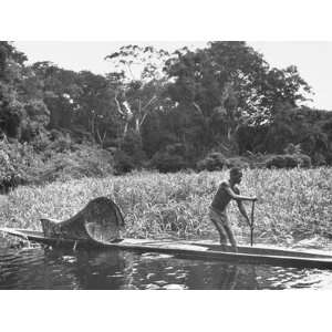  A Local Citizen Rowing a Native Boat with an Onboard 