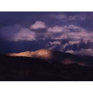 Clouds Gather over Sunlit Mountains in the Andes, Macusani, Puno, Peru 