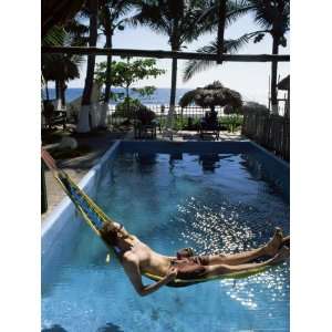 Tourist in Hammock Relaxing Over Pool, Monterico, Guatemala, Central 
