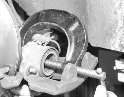 Fig. A c clamp centered in the pistons bore can be used to press a 