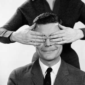  Woman Using Hands To Cover Eyes of Smiling Man 