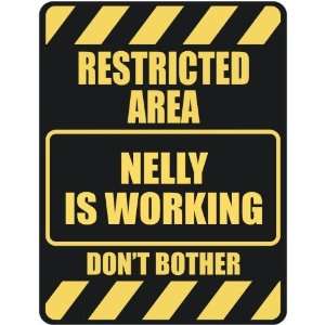   RESTRICTED AREA NELLY IS WORKING  PARKING SIGN