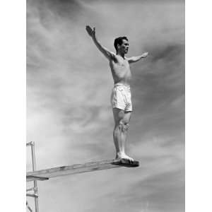 Man in Bathing Suit Standing on End of Diving Board Photographic 